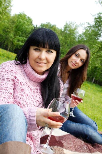 Premium Photo Mother And Daughter Drinking Wine Outdoors