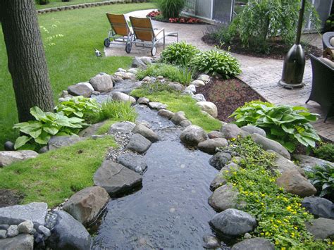Knowing how to water your lawn during the stressful summer conditions is difficult for just about everyone. Waterfall feature for a yard that has a steep rear slope | Waterfalls backyard, Fountains ...