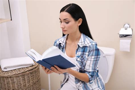 Babe Woman Sitting On Toilet In Public Bathroom Portrait