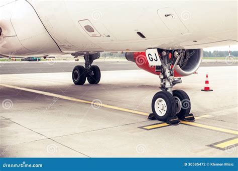 Landing Gear And Undercarriage Of A Jet Airplane Parked Stock