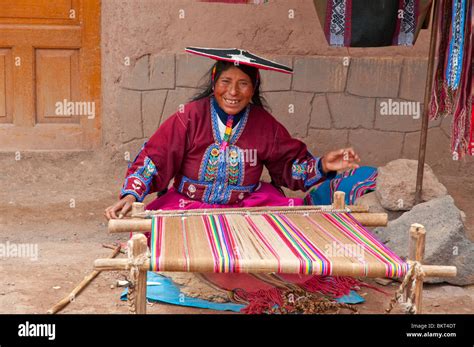 A Peruvian Woman In Traditional Dress Weaving A Blanket In The Plaza In Racchi Peru South