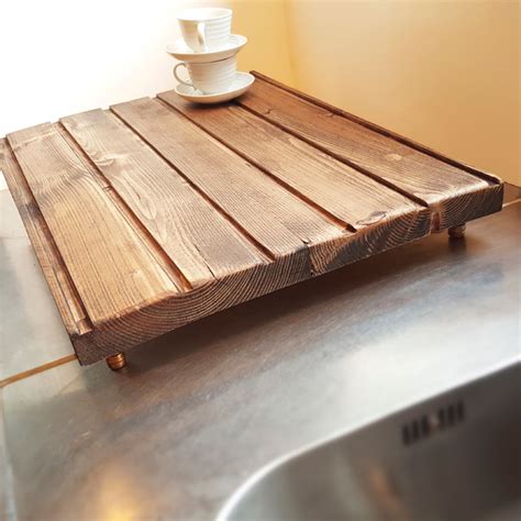 Add functionality to your sink with the addition of a sink strainer, dish drainer, soap dish or dispenser, and dish rack. dark wood draining board with copper legs - Rustic ...