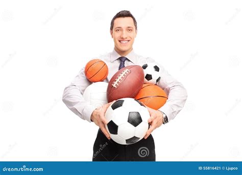 Man Holding A Bunch Of Different Kind Of Sports Balls Stock Image