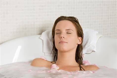 Back view of a young woman bathing in a health spa's flower bath. Relax, recharge, and stress less