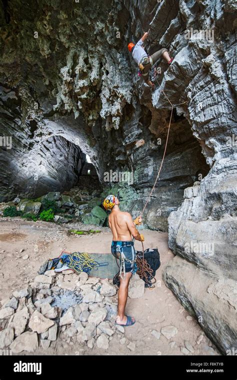 Male Climbers Climbing Treasure Cave In Yangshuo Guangxi Zhuang China