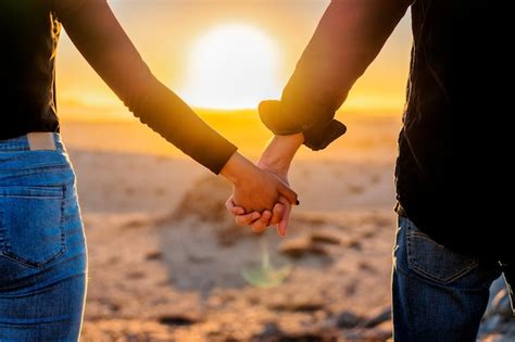 Premium Photo Couple Holding Hands Together At Sunset