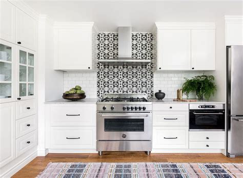 A stunning modern farmhouse kitchen design complete with white cabinets, grey subway tile, wood flooring and wood stained island. 21 White Kitchen Cabinets Ideas for Every Taste