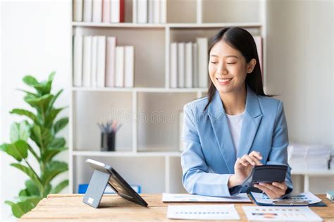 Asian Female Accountant Holding Pen Working On Financial Accounting And