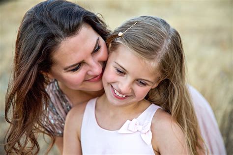 mother kissing daughter turning teen