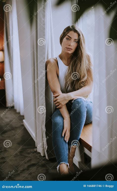 Beautiful Young Woman Sitting By The Window Stock Photo Image Of Long