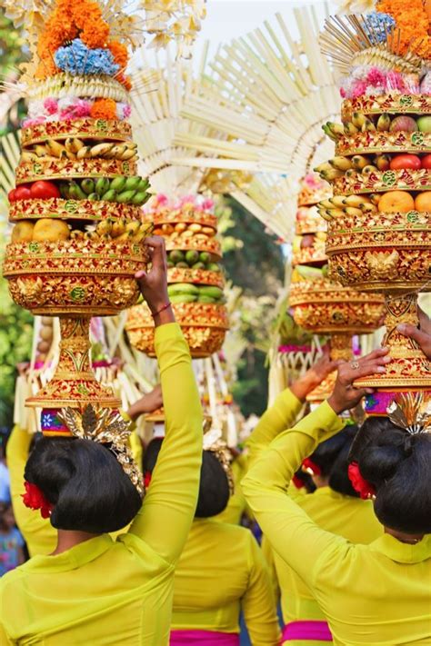 Procession Of Beautiful Balinese Women In Traditional Costumes Carry