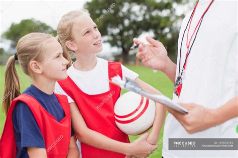 Coach Talking To Children On Soccer Team — Midsection Leadership