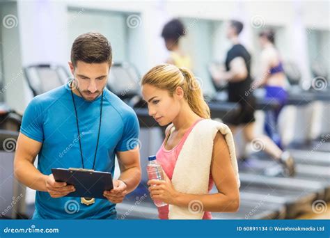 Trainer And Client Discussing Her Progress Stock Photo Image Of