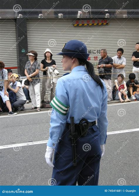 Police Woman Walking In The Street During The Cover 19 Pandemic