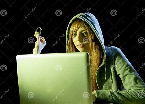 Young Attractive Teen Woman Wearing Hood On Hacking Laptop Computer