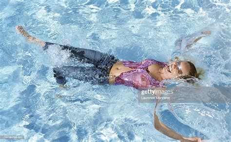 Young Woman Wearing Clothes Swimming In Pool Elevated View Photo
