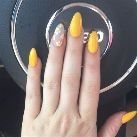 Instead of painting flowers onto your nails, why not try pressed flowers instead? Yellow almond gel nails with flower accent | Almond gel ...