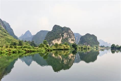 Karst Mountains Reflected In Water In Yangshuo Guangxi Province China