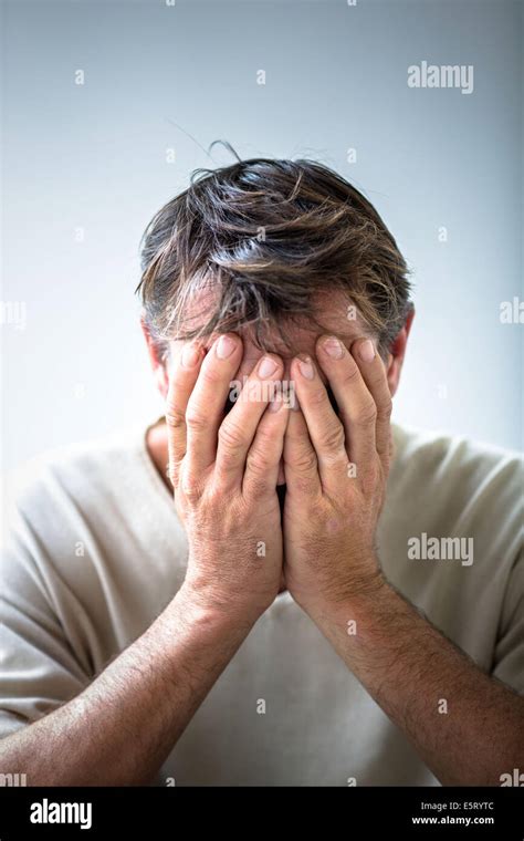 Depressed Man Holding His Head In His Hands Stock Photo Alamy