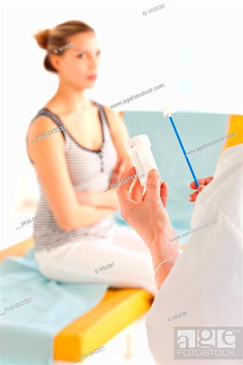 Gynecologist Performing A Cervical Smear Or Pap Test On A Teenage