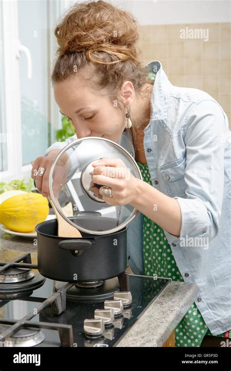 A Young Woman Cooking Dinner In The Kitchen Stock Photo Alamy