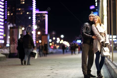 Young Lovers Kissing On The Street At Night In The City Photo