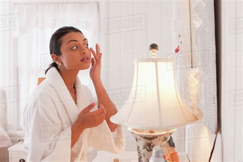 Middle Eastern Woman Applying Lotion Stock Photo Dissolve