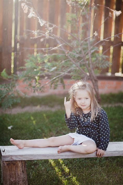 Little Girl Sitting On The Bench By Stocksy Contributor Irina