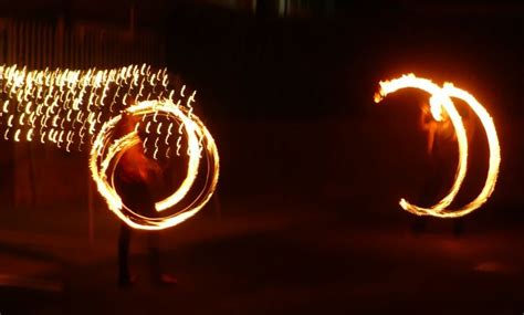 Fairy Light Entrance Tunnel With A Fire Poi Dancer On Either Side Fire