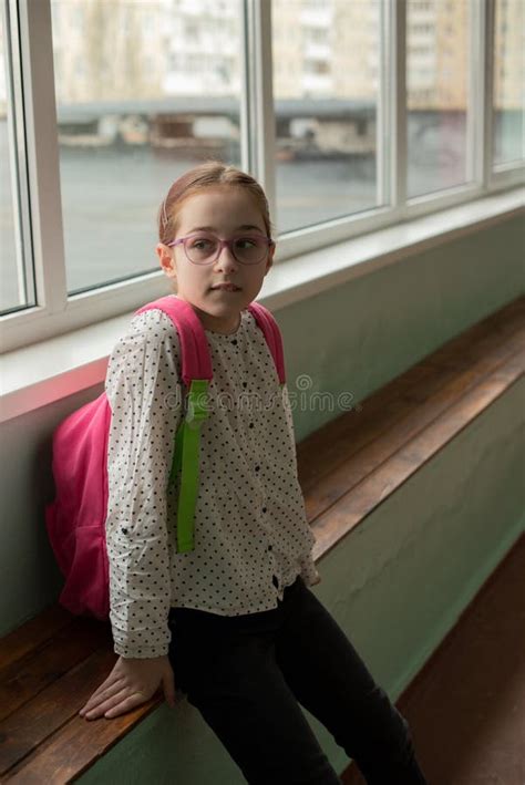 Girl 9 Years Old With A School Backpack On Her Back Portrait Of A