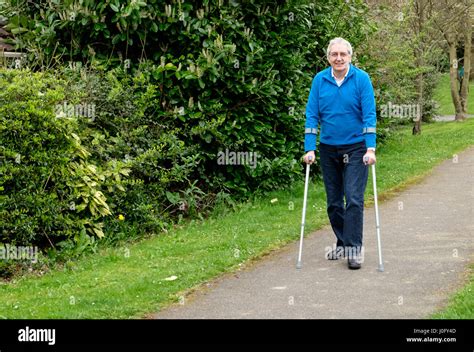 Senior Man On Crutches Taking Exercise Stock Photo Alamy