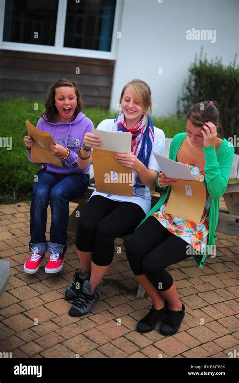 Three School Students Girls Sat Opening Their Exam Gcse Results At