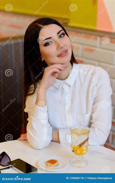 Young Girl Sitting In A Cafe With A Cup Of Tea Stock Photo Image Of