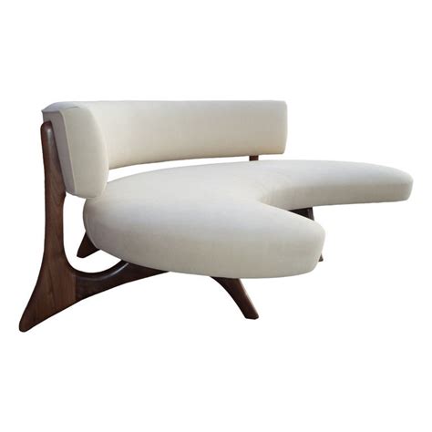 Gray and beige, and is crafted from solid rubberwood. Mid-Century Floating Curved Walnut Sofa at 1stdibs