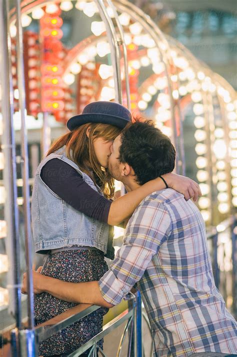 Young Couple Kissing At The Carnival By Stocksy Contributor
