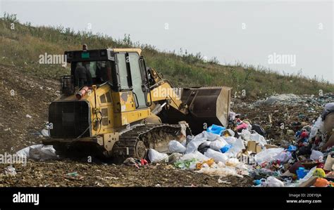 Yellow Tractor Pile Of Garbage Waste Sorting And Preparation For