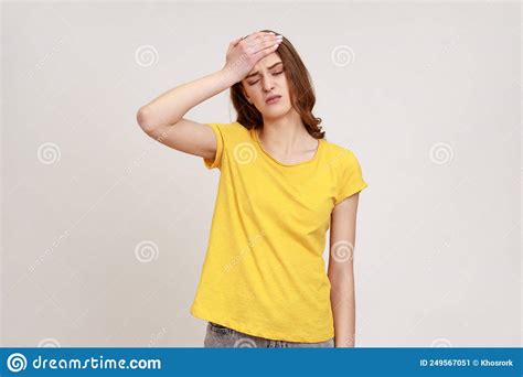 Portrait Of Upset Beautiful Female Of Young Age In Yellow T Shirt