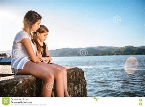 Girl Comforting Her Sad Friend On Dock Stock Image Image