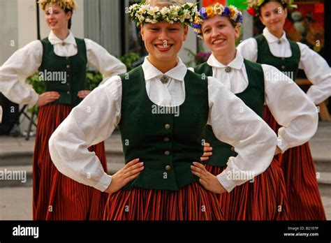 Latvian Folklore Group In National Costumes Dancing During Midsummer