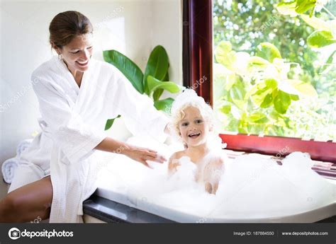 Mother Washing Baby In Bubble Bath Water Fun Stock Photo Famveldman