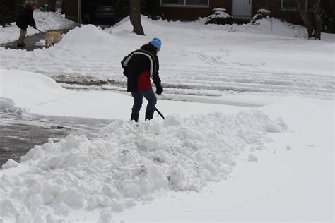 31362919 Lady Shoveling The Deep Snow Off Her Driveway