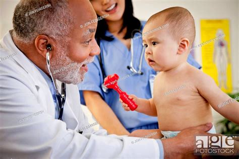Doctor Examining Baby Boy Stock Photo Picture And Royalty Free Image