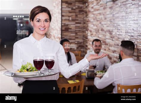 Smiling Female Waitress Carrying Order For Guest Stock Photo Alamy