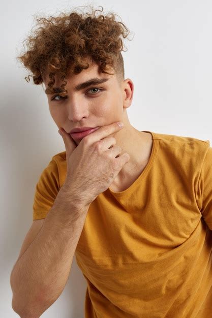 Premium Photo Handsome Young Man In Yellow Tshirts Gesture Hands