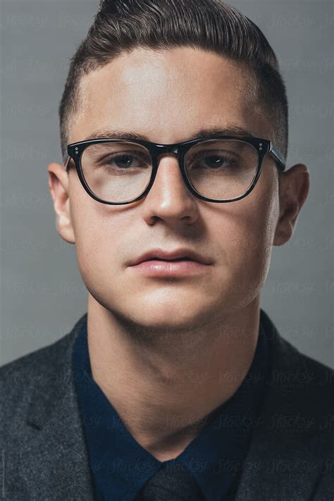 A Portrait Of A Young Man Wearing Black Rimmed Eyeglasses By A Model