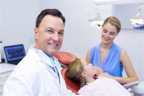 Dentist Smiling At Camera In Dental Clinic Stock Photo Image Of