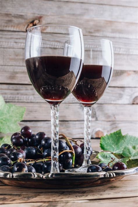 Two Glasses With Red Grape Wine Romantic Dinner Concept Stock Photo