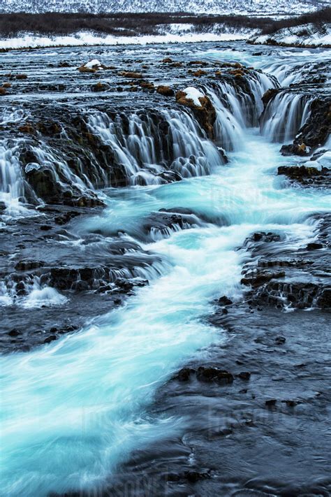 Turquoise Water Flowing Over Rocks Into A River Bruarfoss Iceland