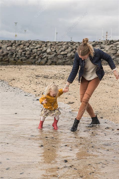 Mother And Toddler Walking At Waters Edge Stock Image F0086112