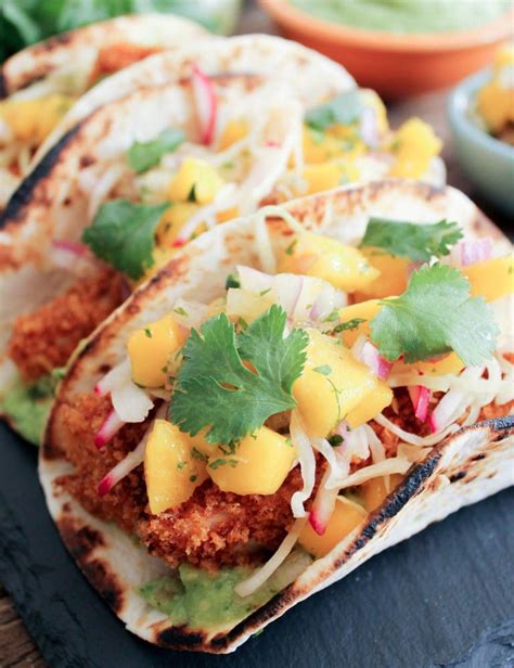When fish is done, place into warm tortillas, top with salsa verde and serve with cabbage, onion mix and garnish of lime, green onion, radish, cilantro, avocado, crumbled cotija. Fish Tacos with Mango Salsa | One of the iconic Baja ...